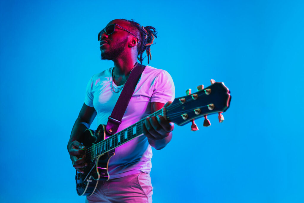 Black session musician playing guitar