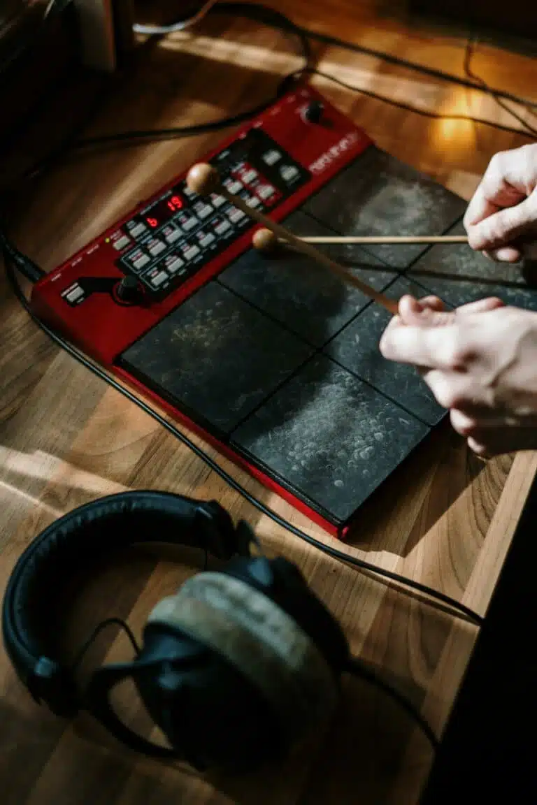 Person playing a digital drum kit, making music from home