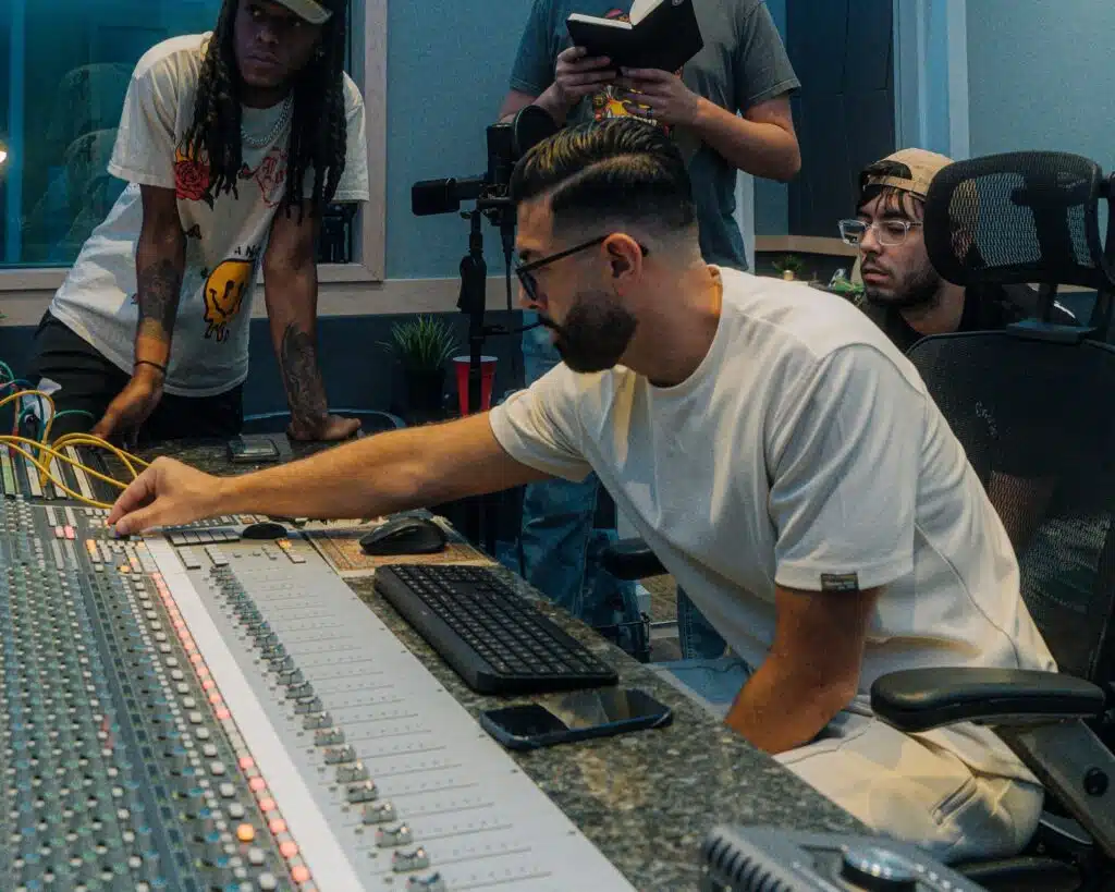 Matthew DeFreitas working on sound board with Bay Eight Sound Academy students