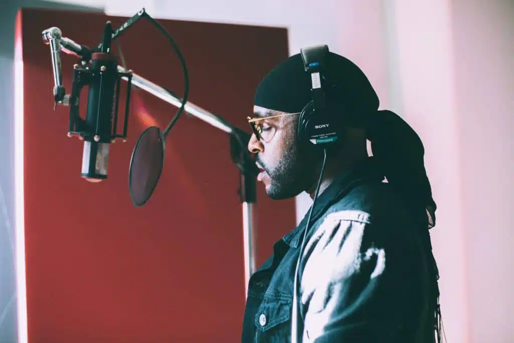 Artists in recording booth “How Much Does It Really Cost to Record a Song in Miami?”