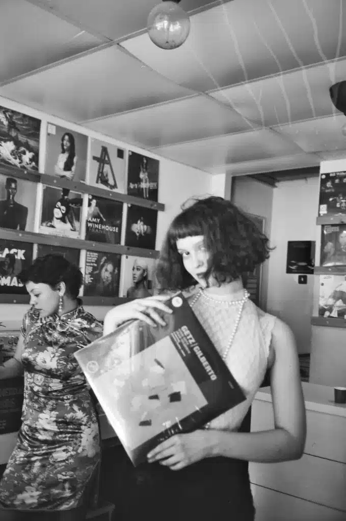 girl in record store black and white music publishing 