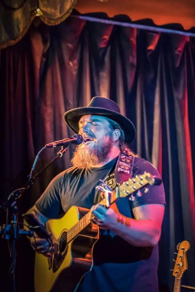 Guide for older musicians bearded guitarist singing in front of mic