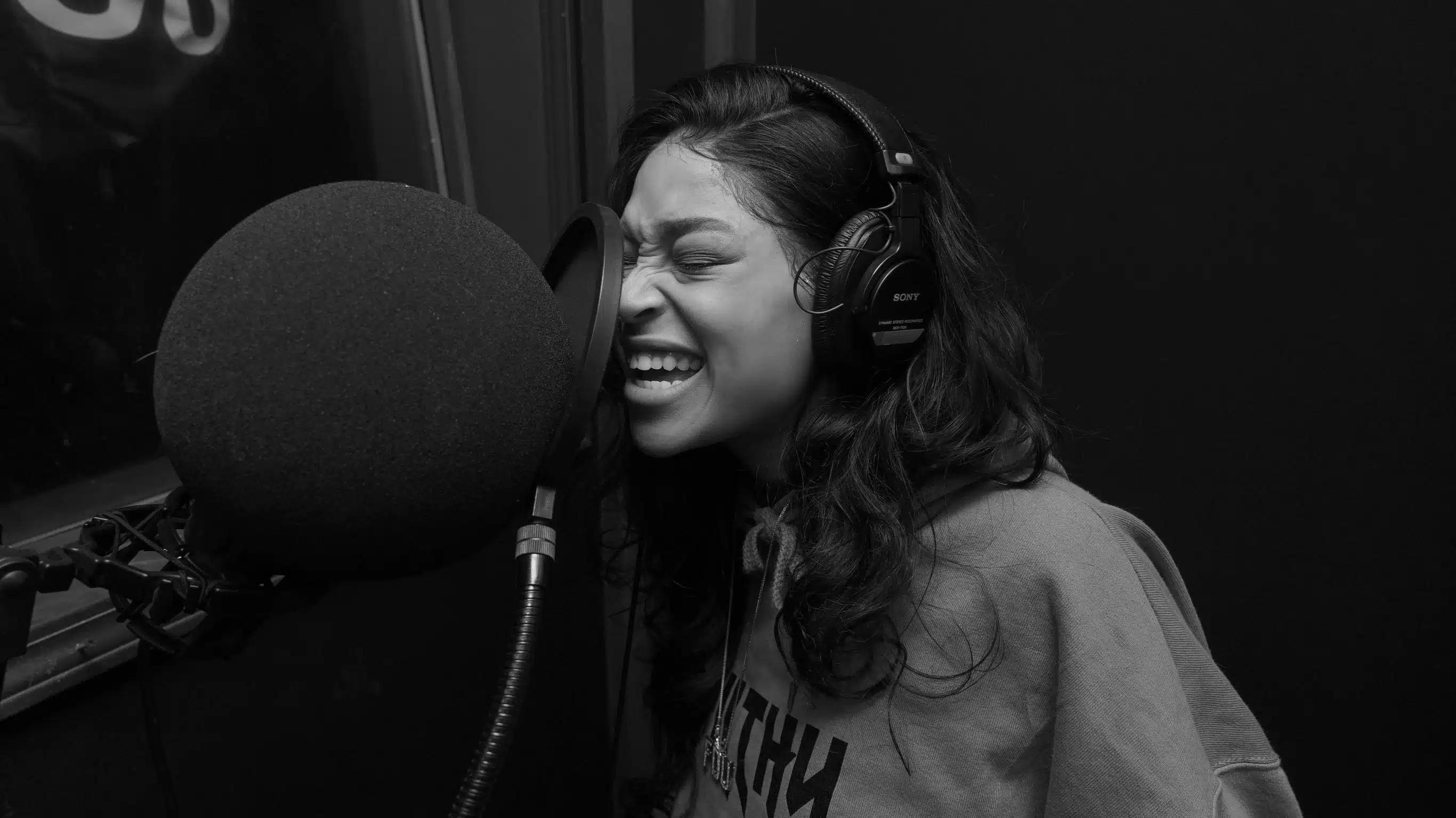 Woman in Gray Crew Neck Shirt Singing While Wearing Black Headphones Pexels Starter Cam 4387718